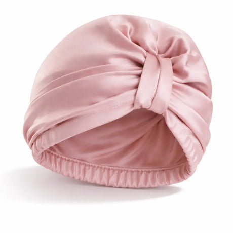 Product foto van roze tulband bonnet met witte achtergrond