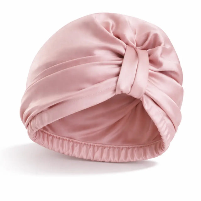 Product foto van roze tulband bonnet met witte achtergrond